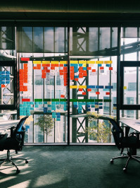 People working with post it notes on an office window