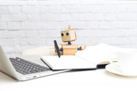 A tiny robot at a desk